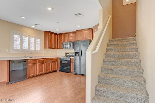 1158 Gecko Rd, Henderson, NV 89002 - kitchen with black appliances, a sink, brown cabinetry, light countertops, and recessed lighting