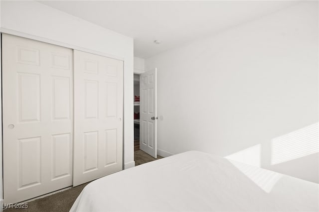 3208 Alcoa Ave, Las Vegas, NV 89102 - bedroom featuring a closet, dark colored carpet, and baseboards