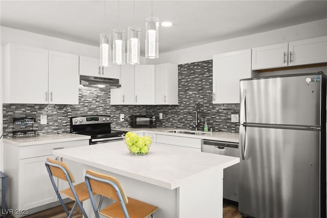 3208 Alcoa Ave, Las Vegas, NV 89102 - kitchen with a sink, under cabinet range hood, light countertops, white cabinets, and appliances with stainless steel finishes