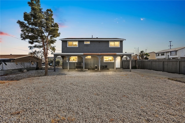 3208 Alcoa Ave, Las Vegas, NV 89102 - back of house at dusk with covered porch, fence, and central AC unit