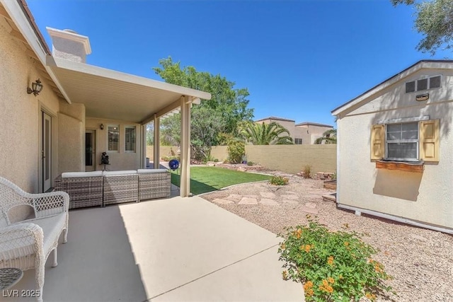 view of patio featuring an outdoor hangout area and a fenced backyard