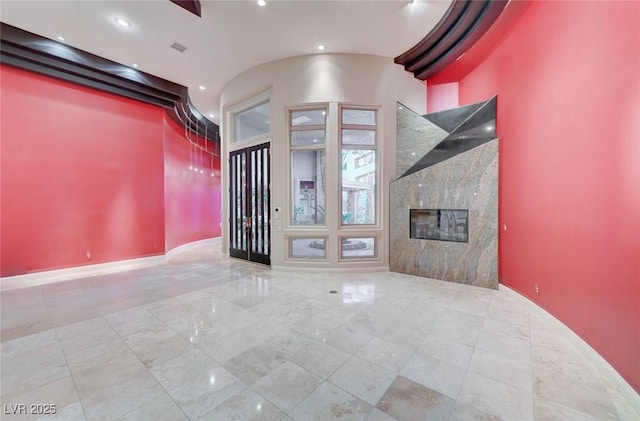 9713 Highridge Dr, Las Vegas, NV 89134 - unfurnished living room with a high end fireplace and recessed lighting