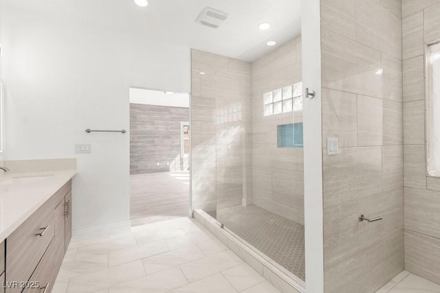 bathroom with recessed lighting, baseboards, visible vents, a shower stall, and vanity