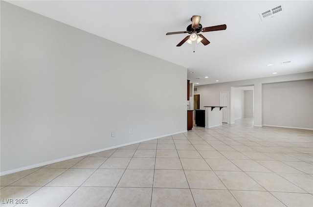 unfurnished living room featuring light tile patterned floors, a ceiling fan, visible vents, baseboards, and recessed lighting