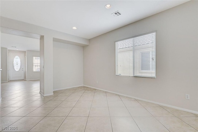 empty room with baseboards, recessed lighting, light tile patterned floors, and visible vents