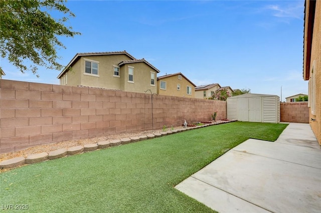 view of yard featuring a fenced backyard, a patio, a storage unit, and an outbuilding