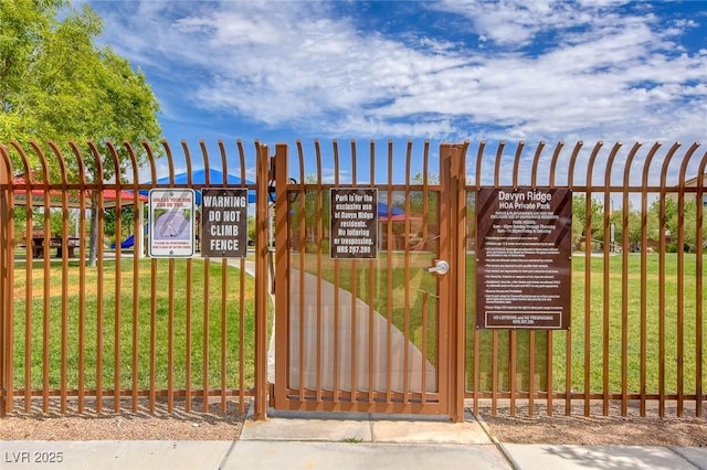view of gate featuring a yard