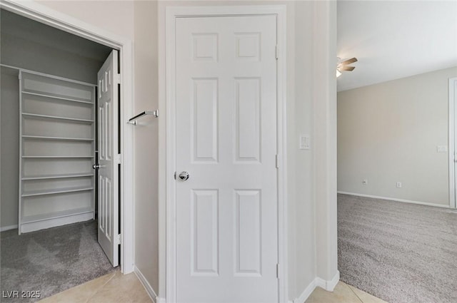hall with carpet and baseboards