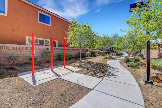 view of property's community featuring fence and a patio area