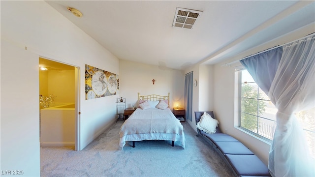 carpeted bedroom with vaulted ceiling, baseboards, and visible vents