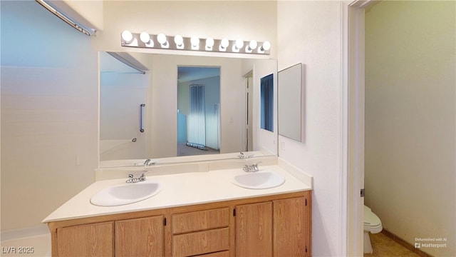 full bath with a sink, double vanity, toilet, and a tub