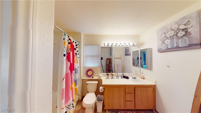 bathroom with toilet, a shower with shower curtain, vanity, and a textured ceiling