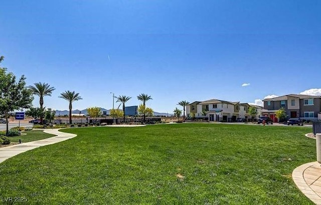view of home's community featuring a lawn and a residential view
