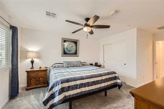 carpeted bedroom with baseboards, a closet, and visible vents