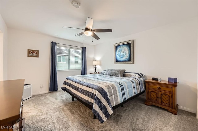 carpeted bedroom with ceiling fan and baseboards