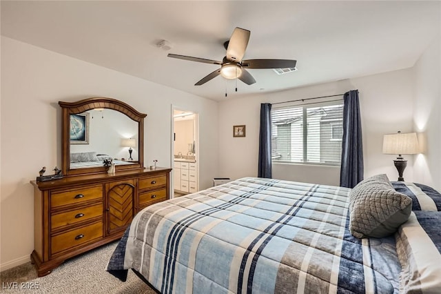 bedroom with light colored carpet, visible vents, ceiling fan, connected bathroom, and baseboards
