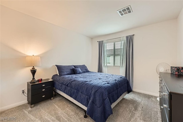 bedroom featuring baseboards, visible vents, and light colored carpet