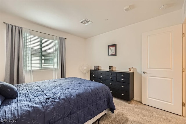bedroom featuring light colored carpet and visible vents