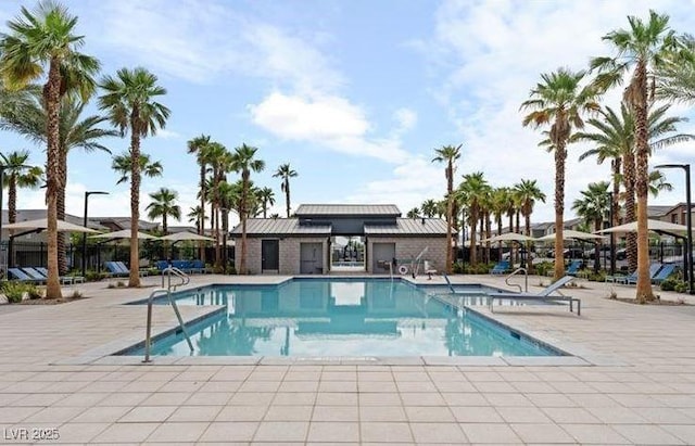 pool featuring fence and a patio