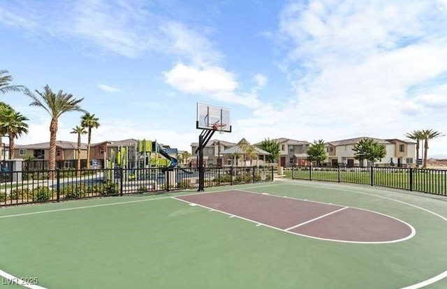 view of basketball court with fence, a residential view, and community basketball court