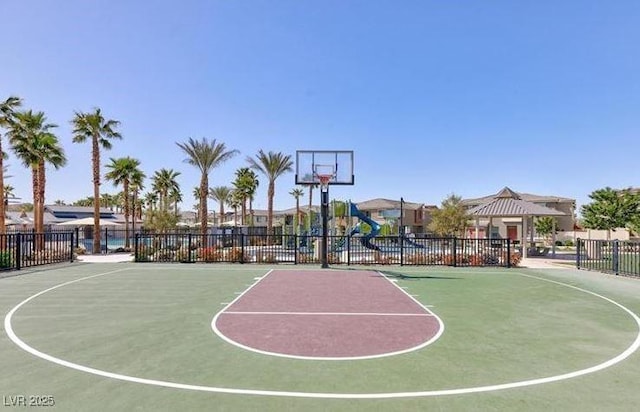 view of sport court featuring fence, playground community, and community basketball court
