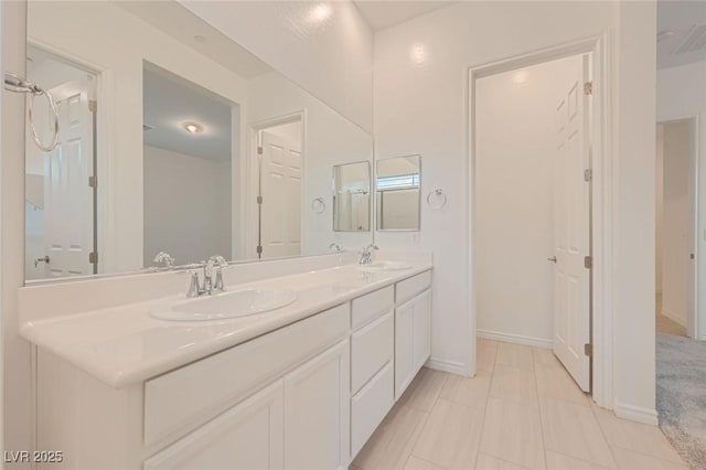 790 Sunny Sagebrush St, Henderson, NV 89011 - bathroom featuring baseboards, double vanity, and a sink