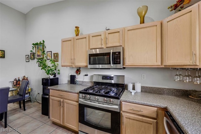 kitchen featuring light countertops, light tile patterned floors, stainless steel appliances, and light brown cabinetry