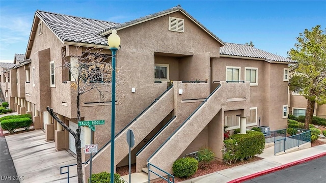 view of front of house with a tile roof and stucco siding