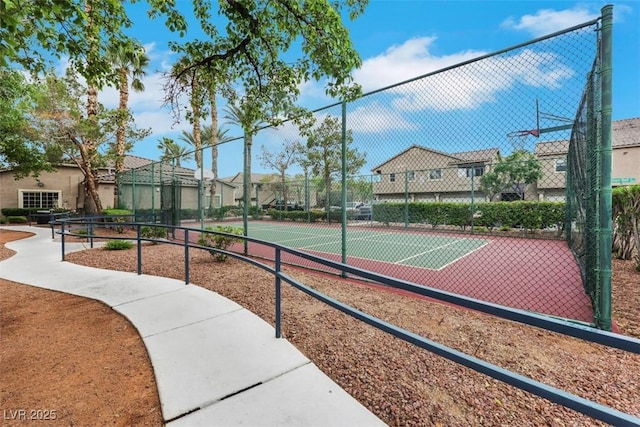 view of sport court featuring fence and a residential view
