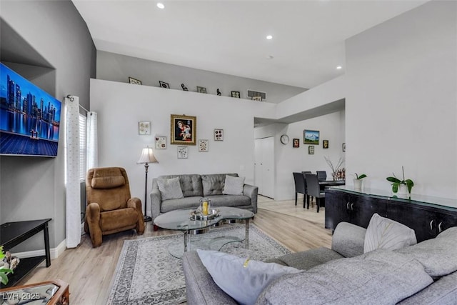 living area with recessed lighting, baseboards, and wood finished floors