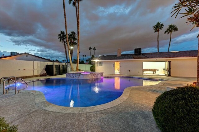 view of pool with cooling unit, a patio area, a pool with connected hot tub, and a fenced backyard