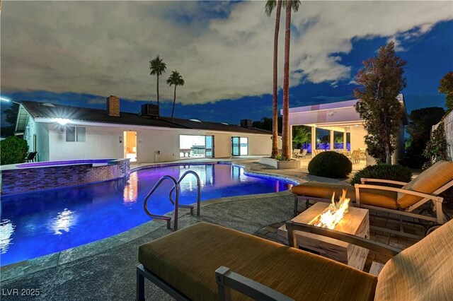 view of pool featuring an outdoor fire pit, central air condition unit, a patio, and a pool with connected hot tub