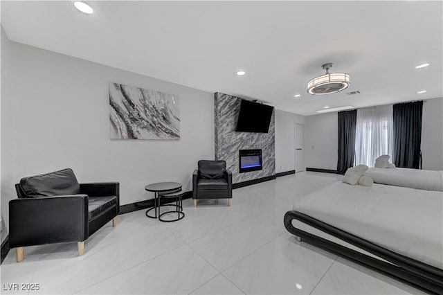 bedroom with recessed lighting, a fireplace, light tile patterned floors, and baseboards