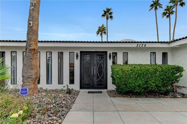 entrance to property with stucco siding