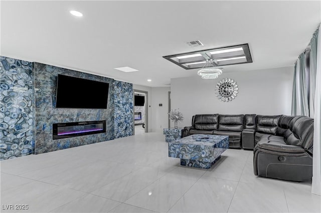 living area featuring a glass covered fireplace, tile patterned floors, and wallpapered walls
