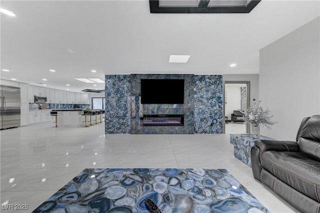 living area with recessed lighting, a fireplace, and light tile patterned floors