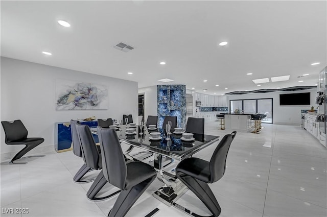 dining room with recessed lighting and light tile patterned floors
