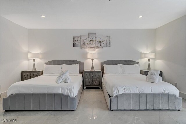 bedroom with marble finish flooring and recessed lighting