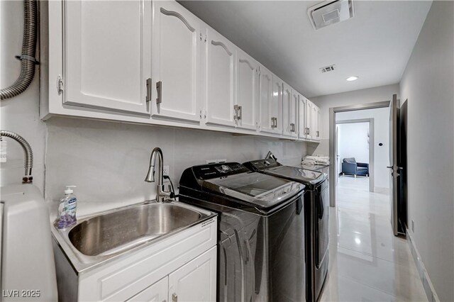 washroom featuring washer and dryer, cabinet space, light tile patterned floors, and recessed lighting