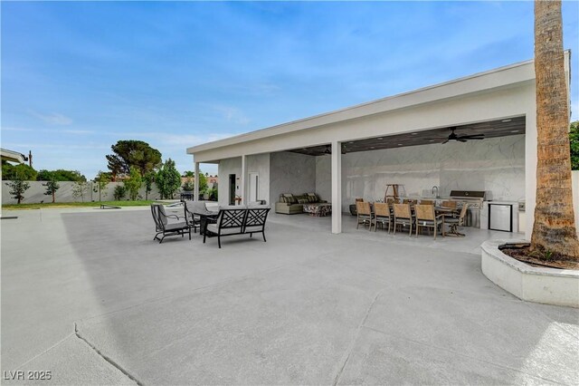 view of patio featuring an outdoor living space, exterior kitchen, outdoor dining area, and a grill
