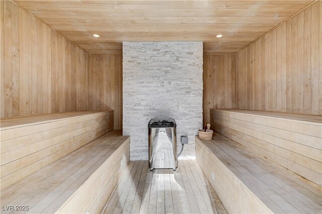 sauna with wooden ceiling and wood walls