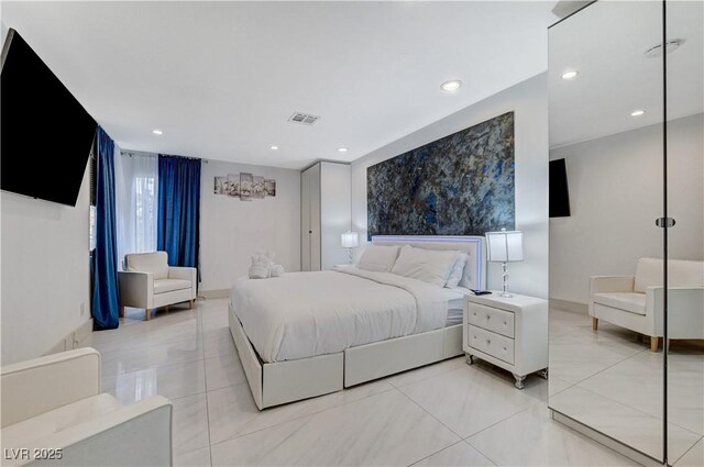 bedroom with light tile patterned floors, baseboards, and recessed lighting