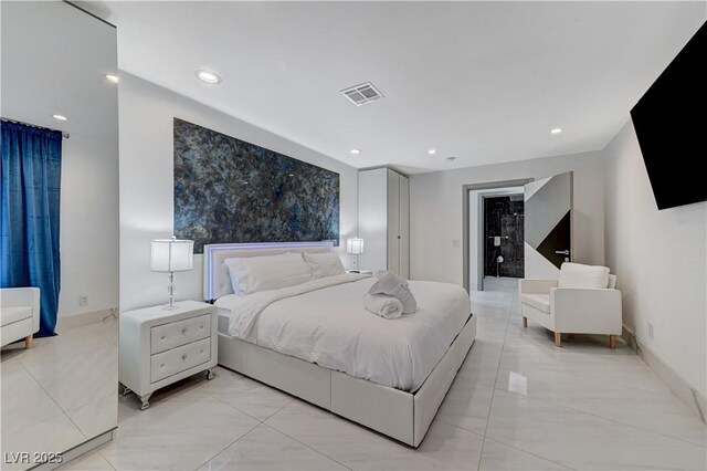 bedroom featuring recessed lighting, an accent wall, baseboards, and light tile patterned flooring
