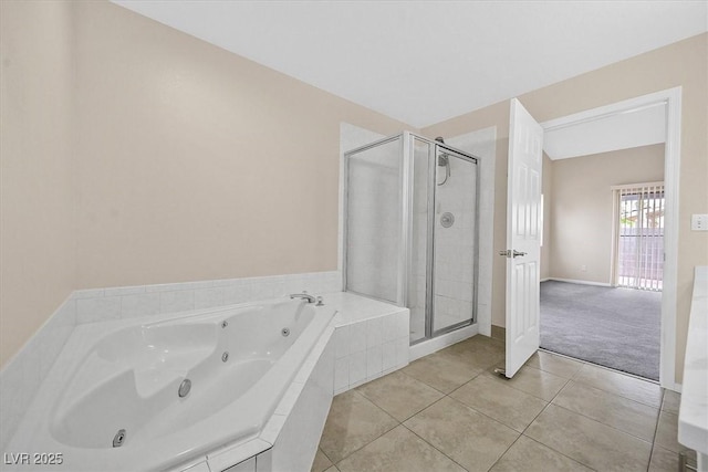5820 Royal Castle Ln, Las Vegas, NV 89130 - bathroom with a shower stall, tile patterned flooring, a whirlpool tub, and baseboards