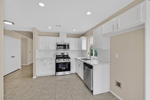 5820 Royal Castle Ln, Las Vegas, NV 89130 - kitchen featuring a sink, stainless steel appliances, visible vents, decorative backsplash, and light countertops