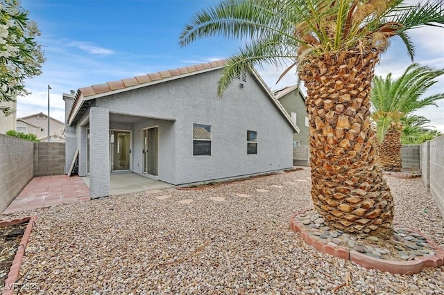 5820 Royal Castle Ln, Las Vegas, NV 89130 - back of house featuring stucco siding, a fenced backyard, and a patio area