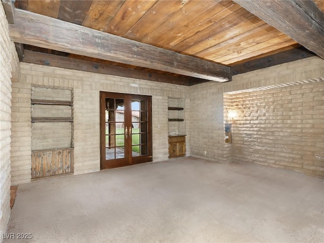 spare room featuring brick wall, french doors, beam ceiling, and wood ceiling
