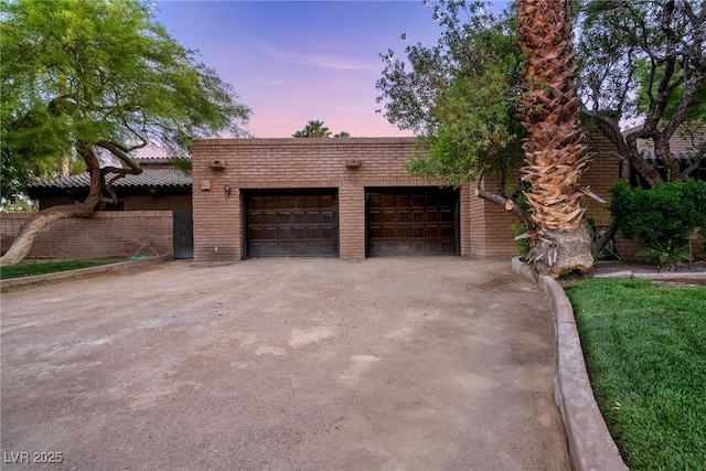 view of front of property with brick siding and a garage