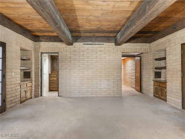 unfurnished living room featuring wooden ceiling, brick wall, visible vents, beamed ceiling, and carpet floors