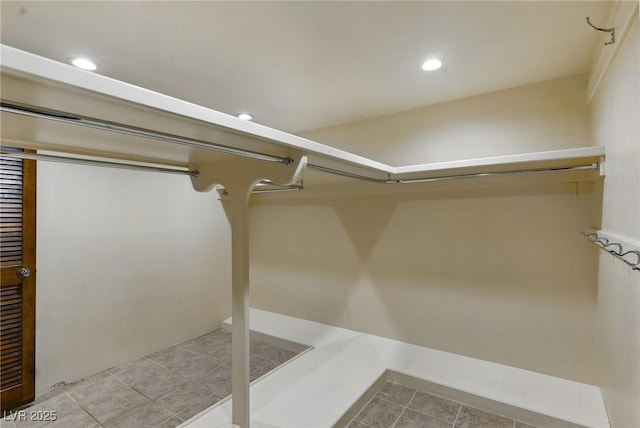 spacious closet with light tile patterned floors